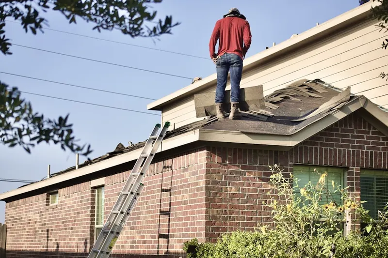 Professional roofer working on a residential roof in West Hampton